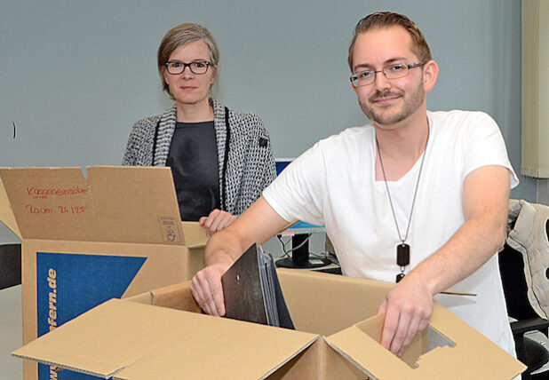 Die Mitarbeiterinnen und Mitarbeiter der Lippstädter Kfz-Zulassungsstelle, hier Larissa Schindler und Christian Bierfreund, organisieren vom 14. bis 18. September den Umzug zur Mastholter Straße und packen Umzugskarton. Die Wiedereröffnung erfolgt am 21. September 2015 (Foto: Wilhelm Müschenborn/Kreis Soest).